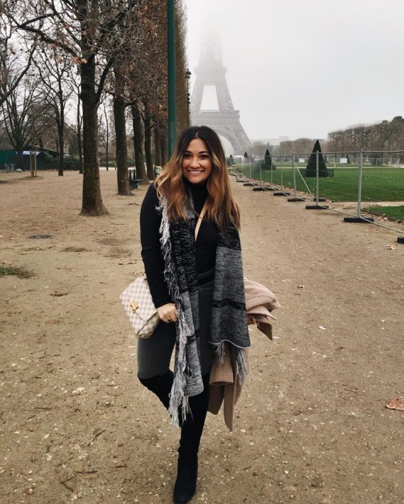 student standing in paris with eiffel tower in the background