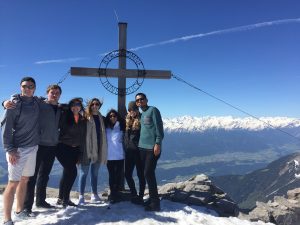 students atop a mountain in europe