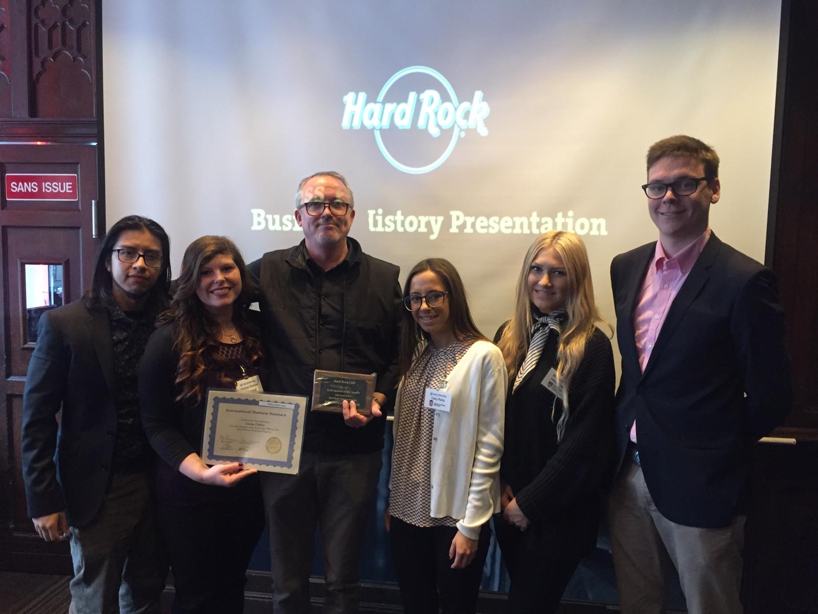 Ashley with business professionals at a company visit with Hard Rock Cafe