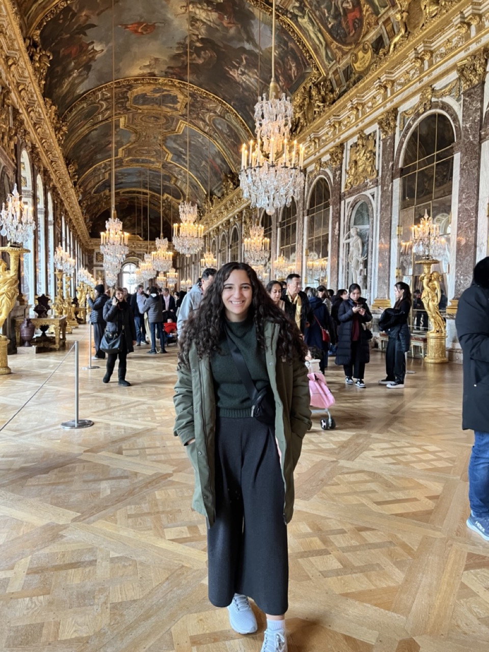 Young woman standing inside a hall in Versailles